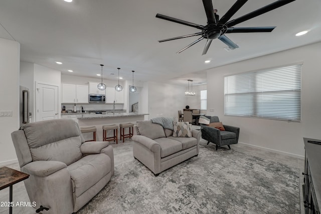 living room featuring ceiling fan and a healthy amount of sunlight