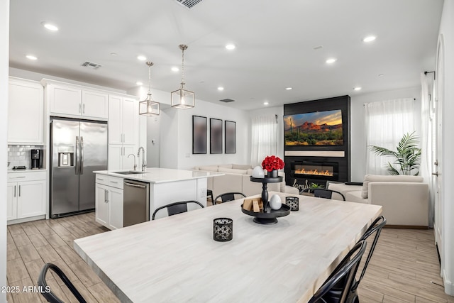 4077 S Sabrina Dr Unit 14, Chandler, AZ 85248 - dining room with recessed lighting, visible vents, a large fireplace, and wood tiled floor
