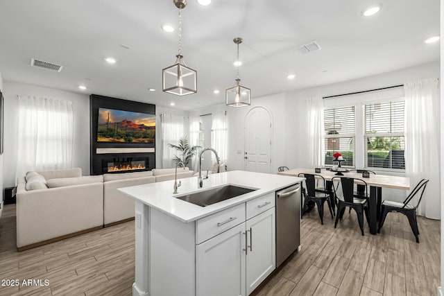 4077 S Sabrina Dr Unit 14, Chandler, AZ 85248 - kitchen with visible vents, dishwasher, a sink, light countertops, and a fireplace