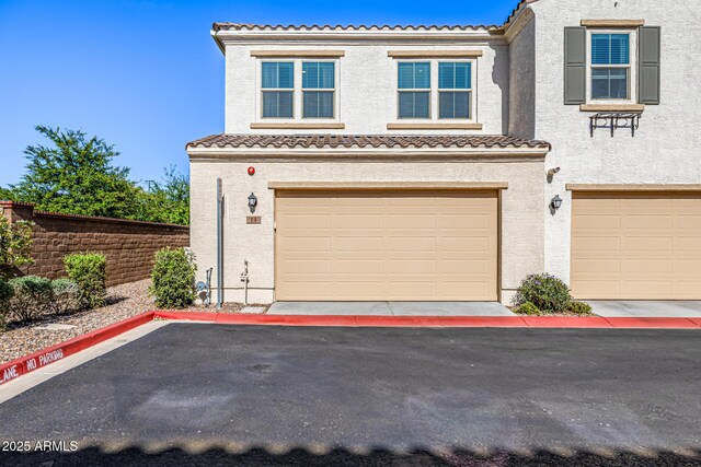 4077 S Sabrina Dr Unit 14, Chandler, AZ 85248 - exterior space featuring a garage, stucco siding, fence, and a tile roof