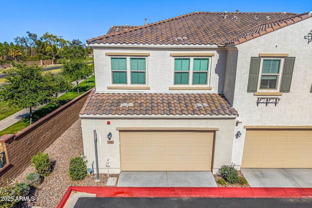 4077 S Sabrina Dr Unit 14, Chandler, AZ 85248 - view of front of house featuring a garage, stucco siding, and a tiled roof