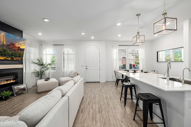 4077 S Sabrina Dr Unit 14, Chandler, AZ 85248 - living area featuring light wood-type flooring, recessed lighting, a glass covered fireplace, and baseboards