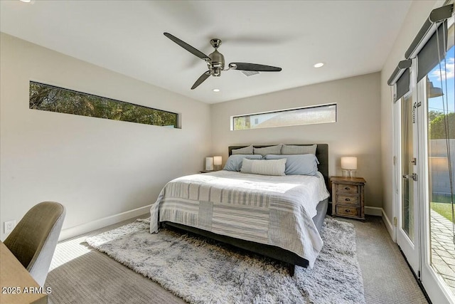 carpeted bedroom featuring access to exterior, ceiling fan, multiple windows, and baseboards