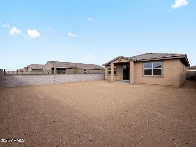 back of property with a patio