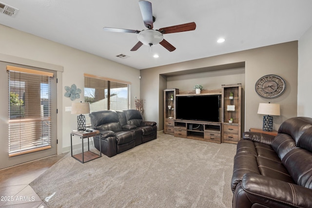 living room with light colored carpet and ceiling fan