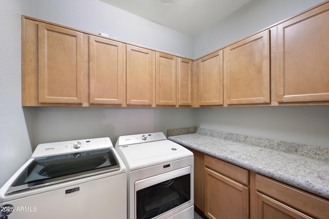 washroom featuring independent washer and dryer and cabinets