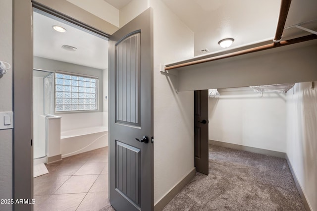 spacious closet featuring tile patterned flooring