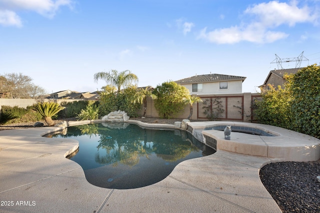 view of swimming pool featuring an in ground hot tub