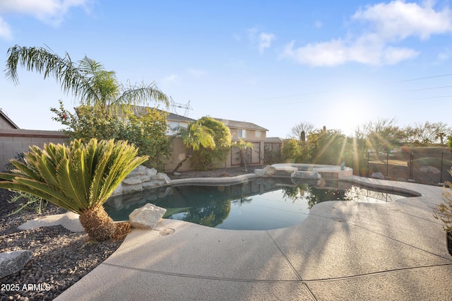 view of pool with a patio area and an in ground hot tub