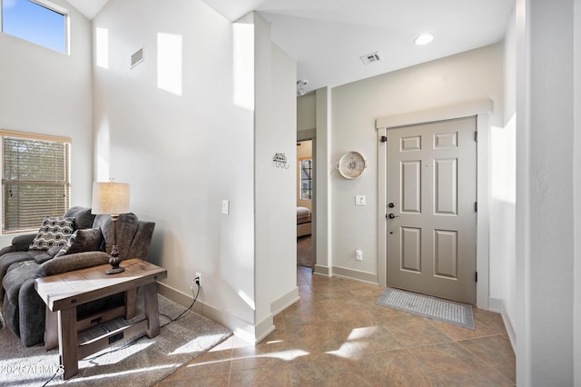 entrance foyer featuring a towering ceiling