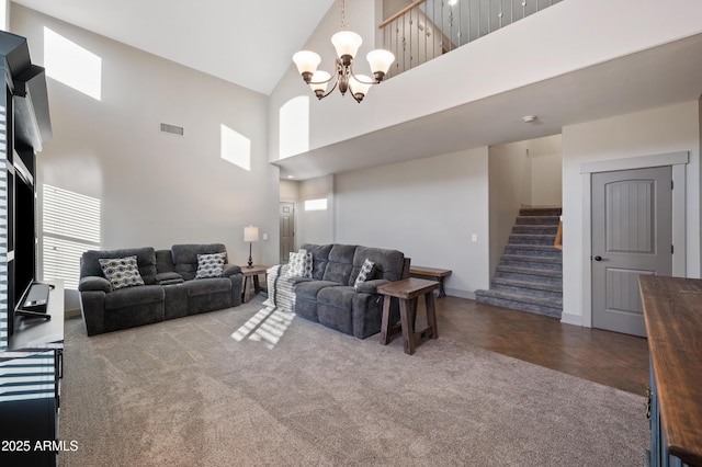 carpeted living room with an inviting chandelier and high vaulted ceiling