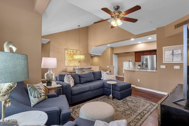 living room with lofted ceiling, sink, ceiling fan with notable chandelier, and dark hardwood / wood-style flooring