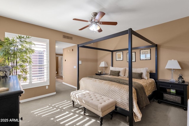 bedroom with ceiling fan, carpet flooring, and multiple windows