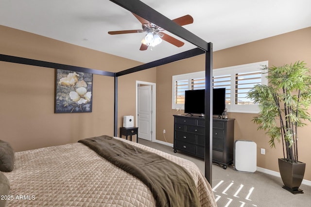 carpeted bedroom featuring beamed ceiling and ceiling fan