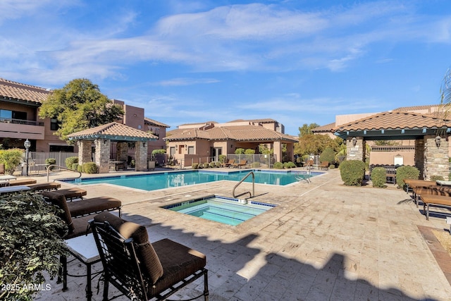 view of swimming pool featuring a gazebo, a patio area, and a community hot tub