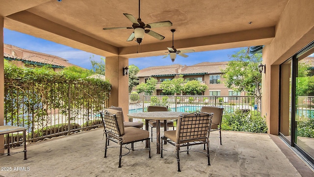 view of patio with a fenced in pool and ceiling fan