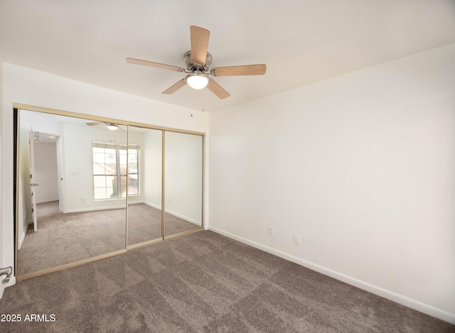 unfurnished bedroom featuring carpet flooring, a closet, baseboards, and ceiling fan