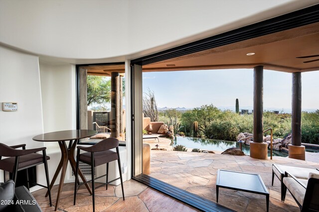 doorway with light hardwood / wood-style flooring, floor to ceiling windows, and a water view