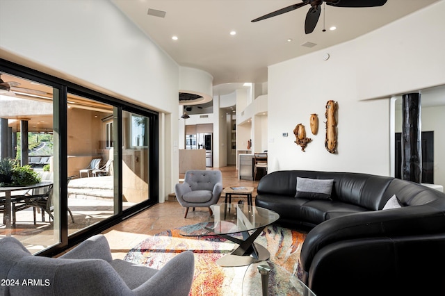 living room with a high ceiling and ceiling fan