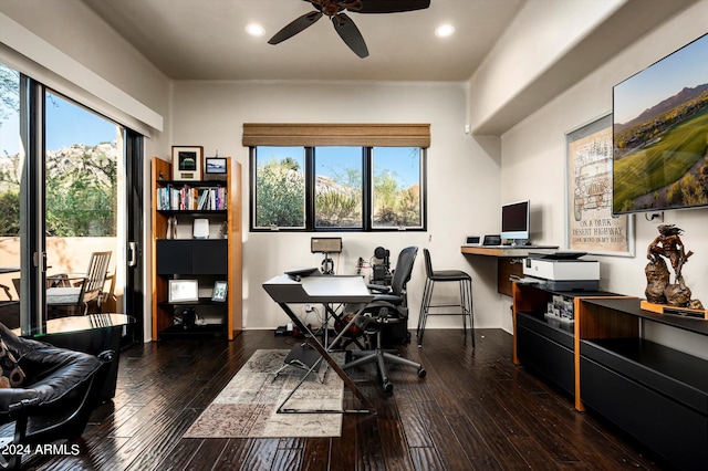 office featuring ceiling fan, dark wood-type flooring, and a wealth of natural light