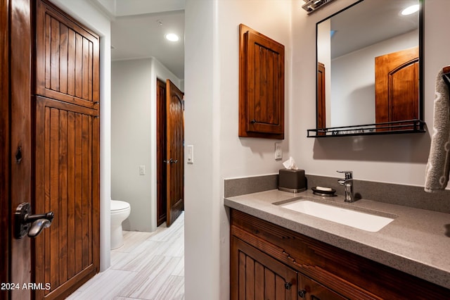 bathroom featuring vanity and toilet