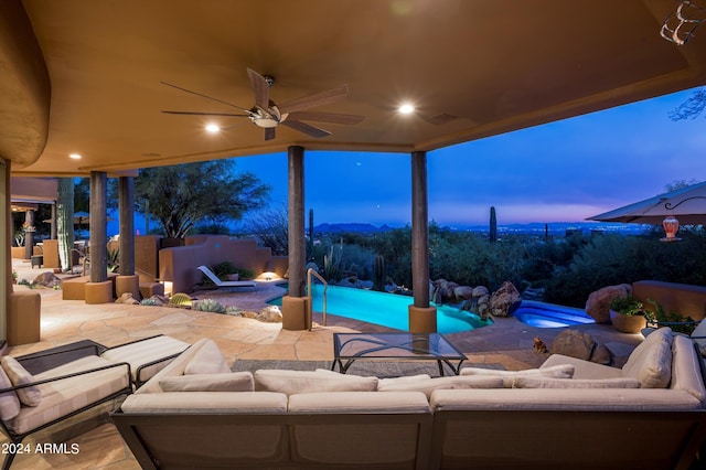 patio terrace at dusk featuring ceiling fan