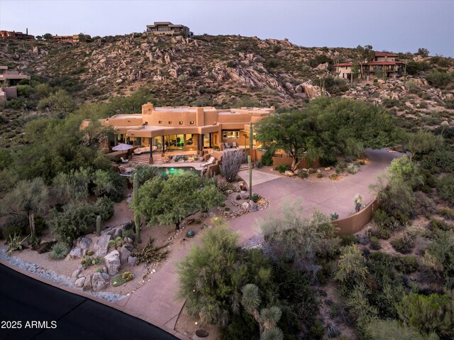 pool at dusk with a patio