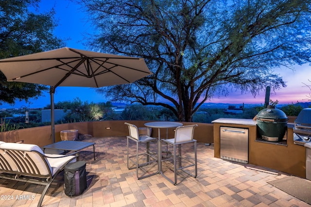 patio terrace at dusk with area for grilling and grilling area