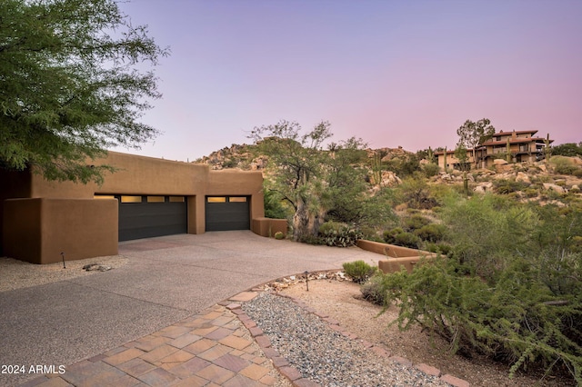 pueblo revival-style home with a garage