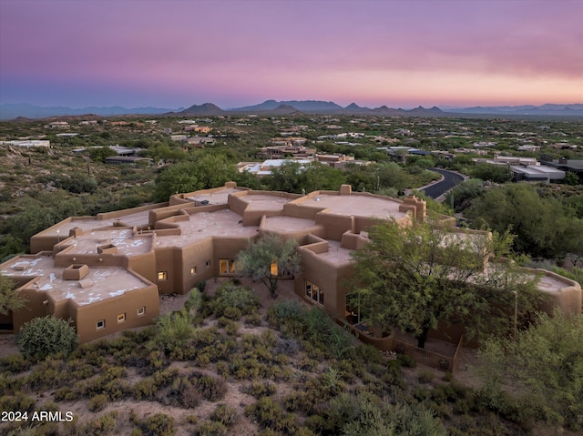 aerial view at dusk featuring a mountain view