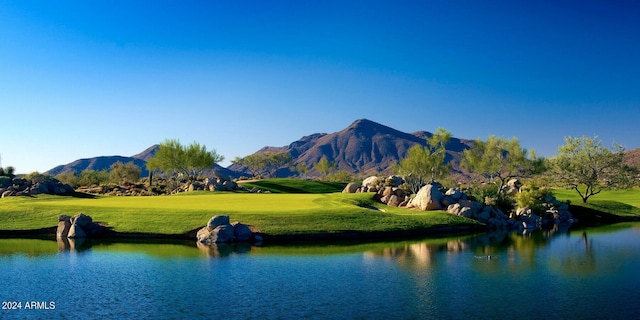 view of community featuring a yard and a water and mountain view