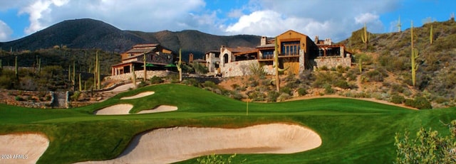 view of community with a mountain view and a lawn