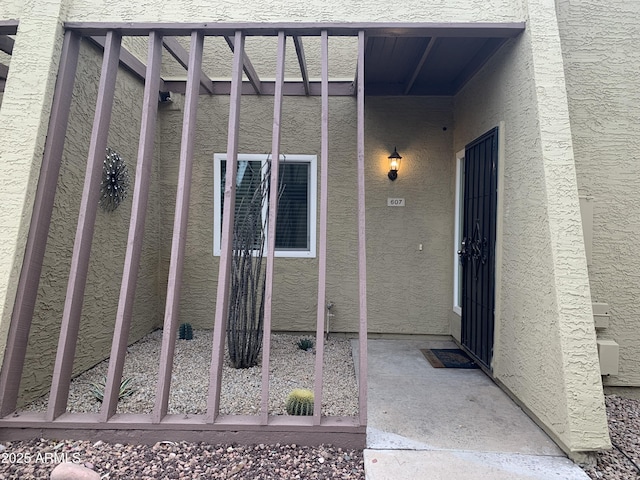 view of exterior entry with stucco siding