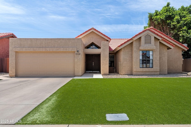 11131 E Becker Ln, Scottsdale, AZ 85259 - view of front of home featuring concrete driveway, an attached garage, a front yard, a tile roof, and stucco siding