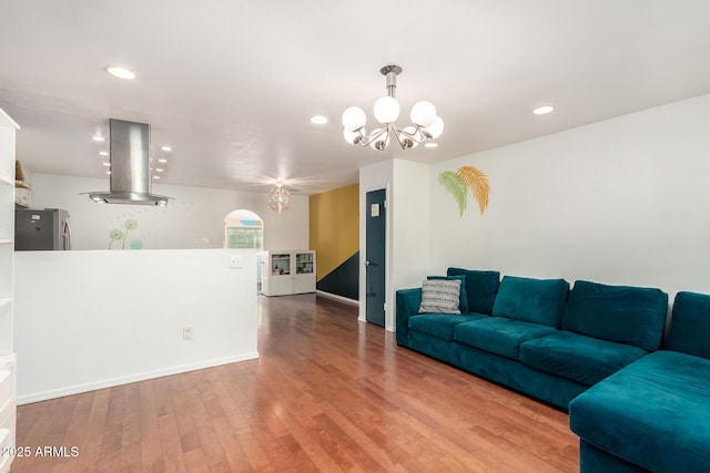 living room featuring wood-type flooring and an inviting chandelier