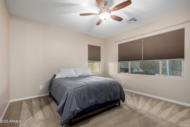 bedroom with ceiling fan and light carpet