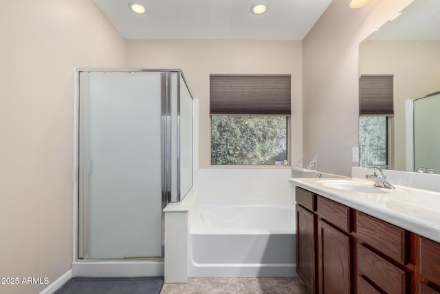 bathroom featuring plus walk in shower and vanity