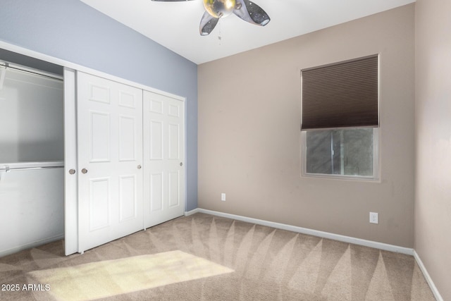 unfurnished bedroom with carpet flooring, ceiling fan, and a closet