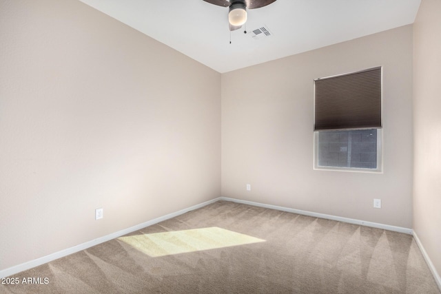 carpeted spare room with ceiling fan