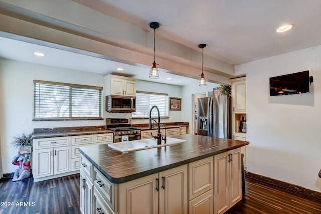 kitchen with a center island, sink, stainless steel appliances, dark wood-type flooring, and pendant lighting