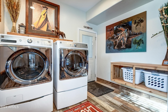 laundry room featuring washer and clothes dryer and wood-type flooring