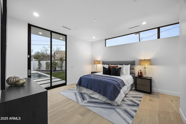 bedroom with access to exterior, visible vents, multiple windows, and expansive windows