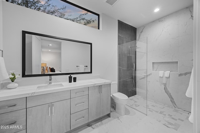 full bath featuring vanity, visible vents, marble finish floor, and a marble finish shower