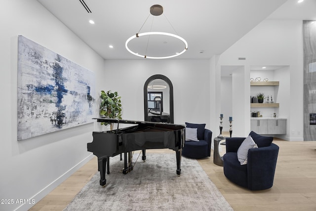 sitting room with recessed lighting, light wood-style flooring, visible vents, and baseboards