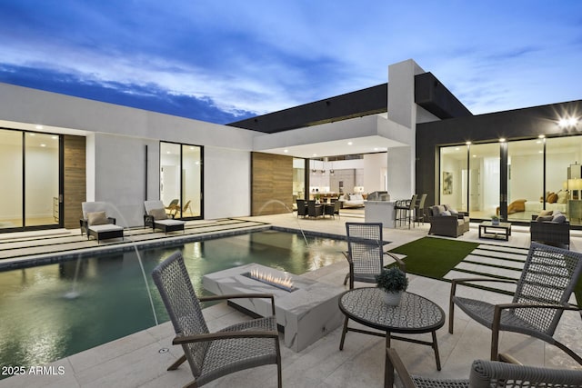 pool with an outdoor living space and a patio