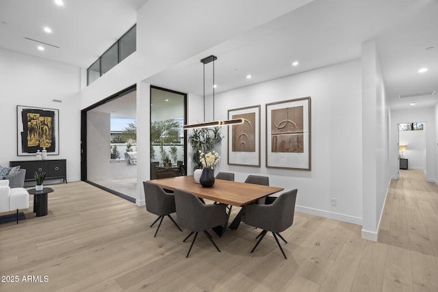 dining space with recessed lighting, baseboards, plenty of natural light, and light wood-style flooring