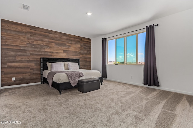 bedroom with wood walls and carpet floors