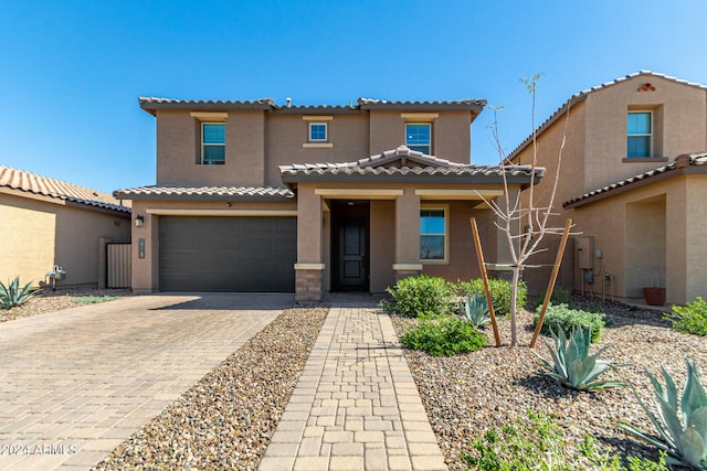 mediterranean / spanish-style house with a garage