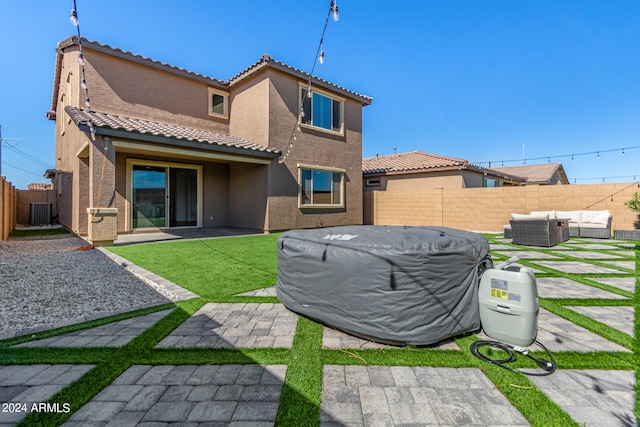 rear view of property featuring a patio area