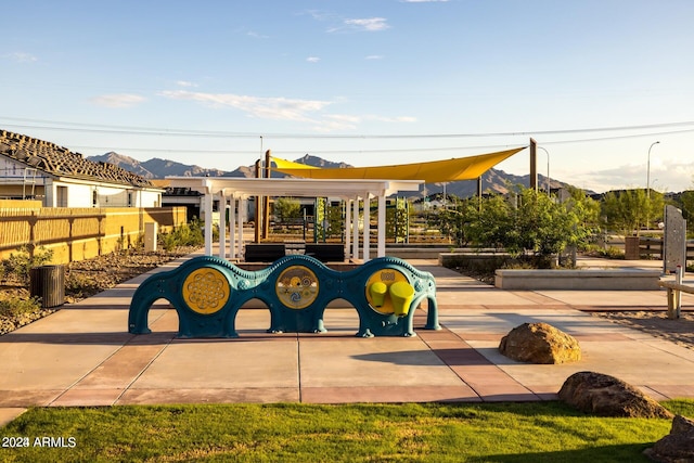 view of jungle gym featuring a mountain view